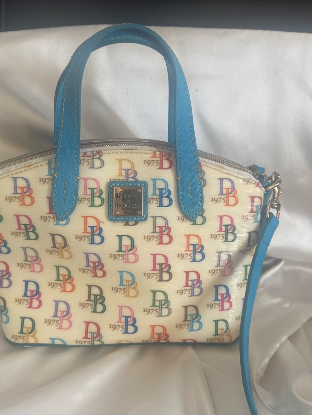 Dooney & Bourke Cream Satchel with Blue Leather Trim and Multicolor Logo